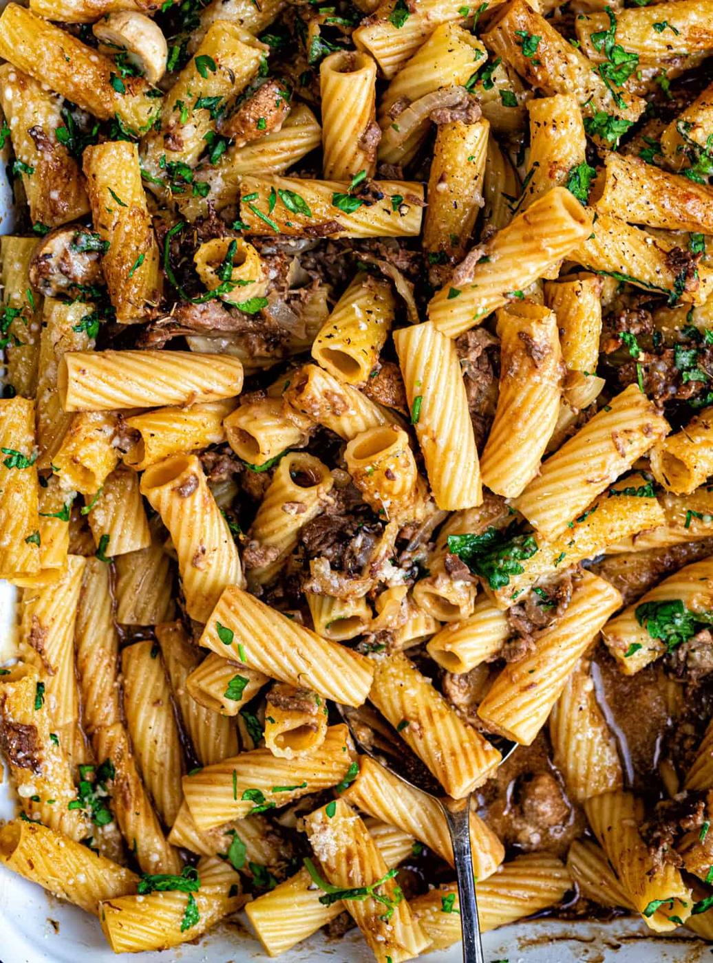 Close up on Beef Stroganoff Pasta Bake with beef and mushrooms, garnished with chopped parsley