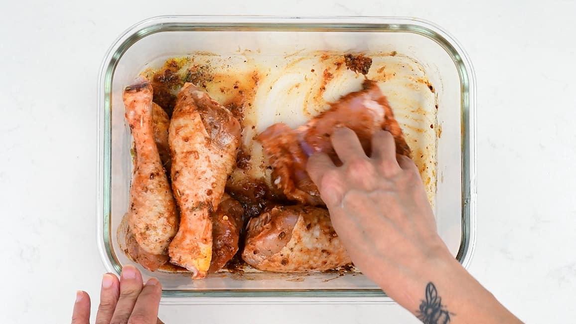 rubbing chicken pieces with homemade peri peri marinade