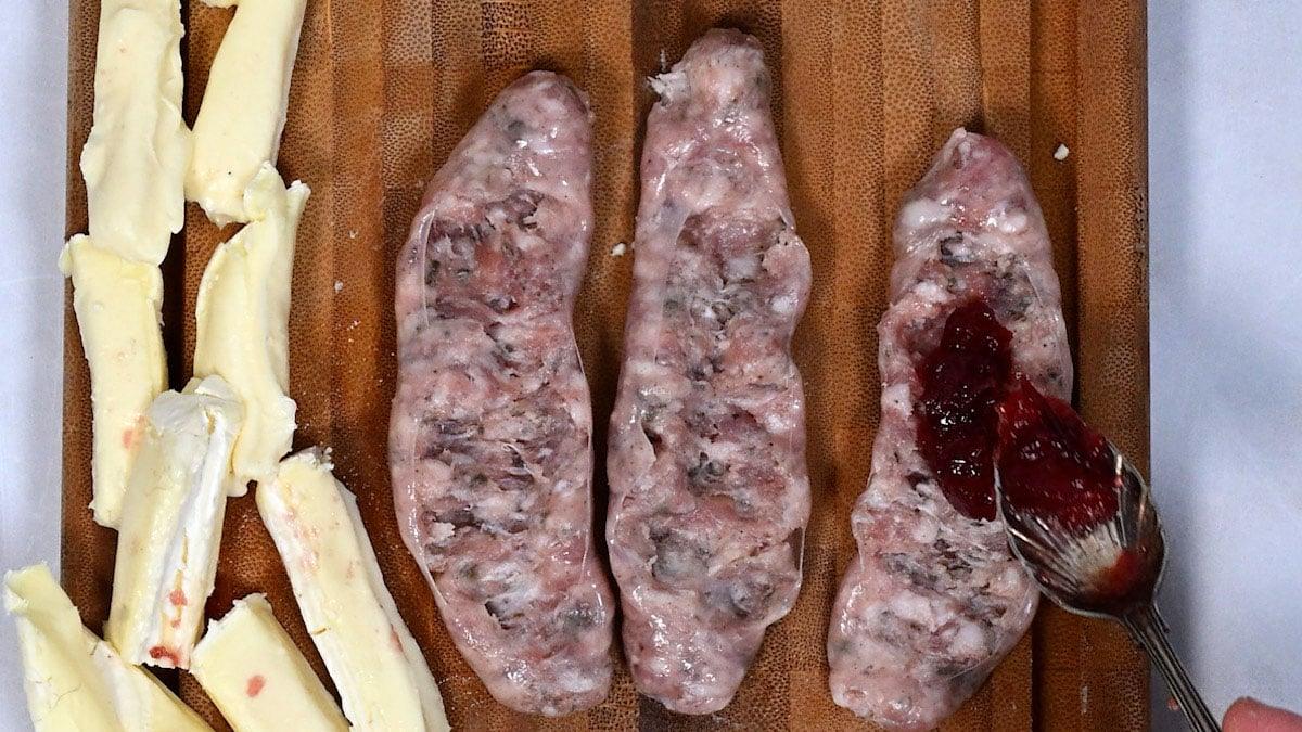 filling sausages with cranberry sauce
