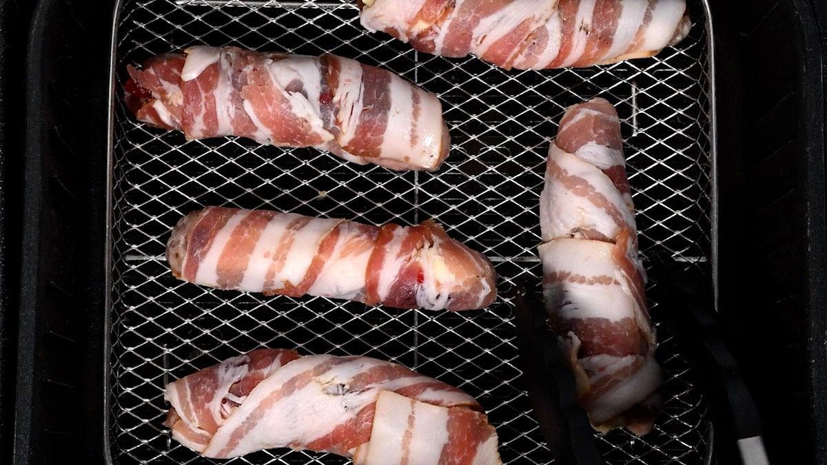 pigs in a blanket in the basket of an air fryer