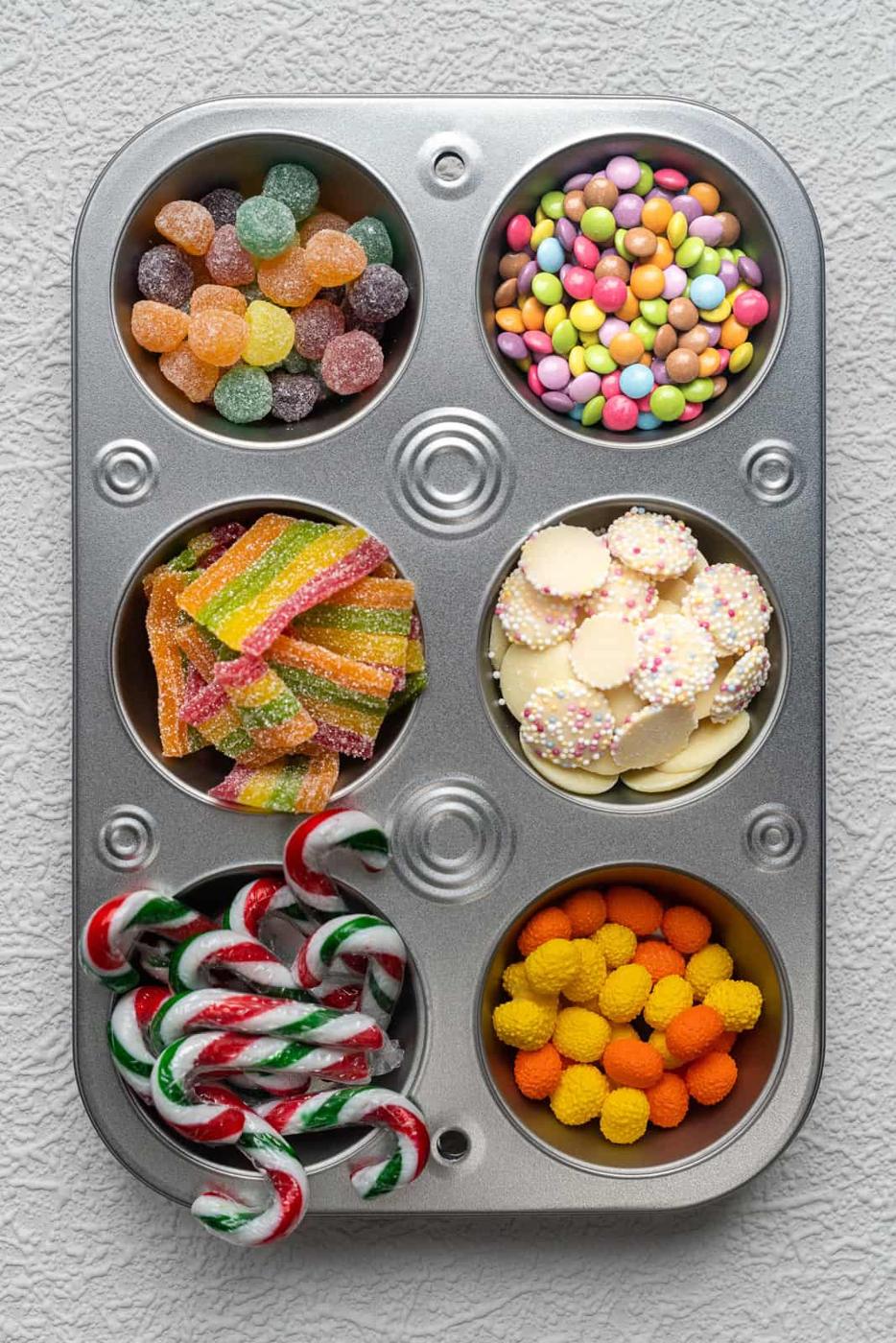 selection of candy in a muffin tin