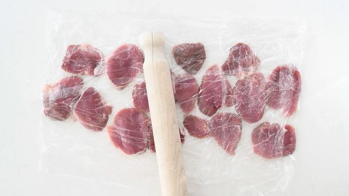 Flattening pork tenderloin with a rolling pin