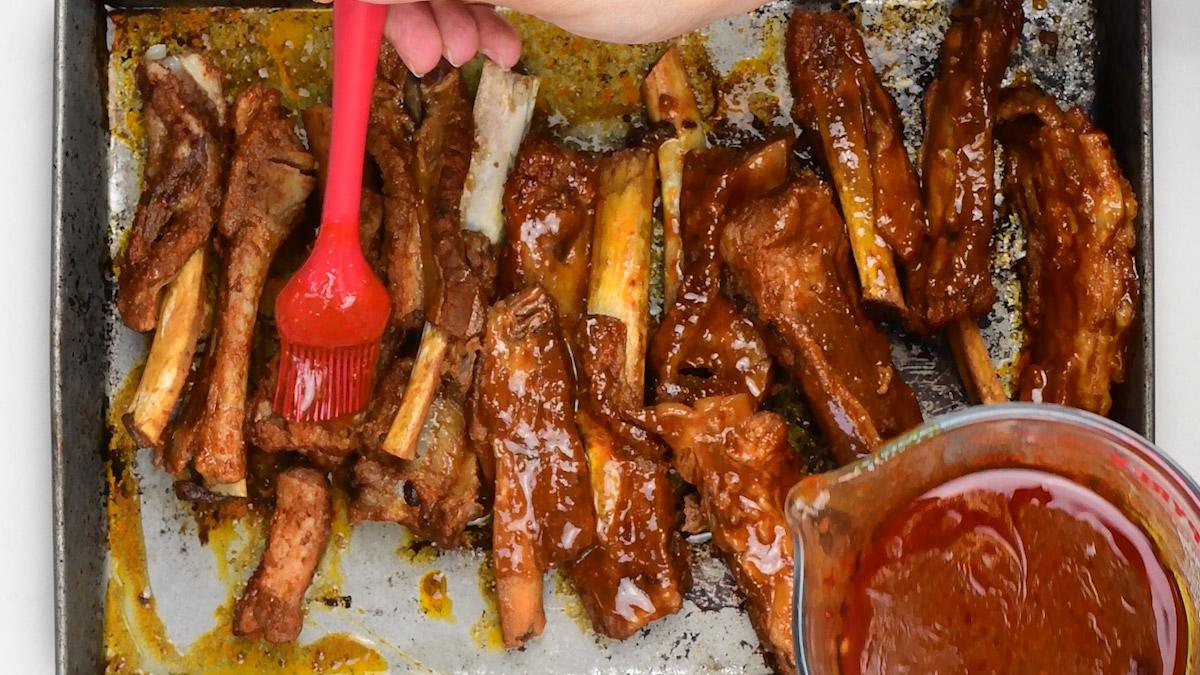 brushing pork ribs with sticky glaze