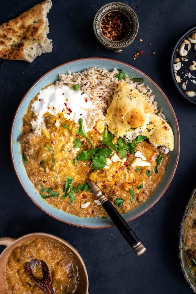 Lamb korma curry served with rice and yoghurt
