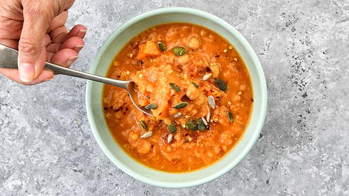 Sweet potato soup in a green bowl overhead