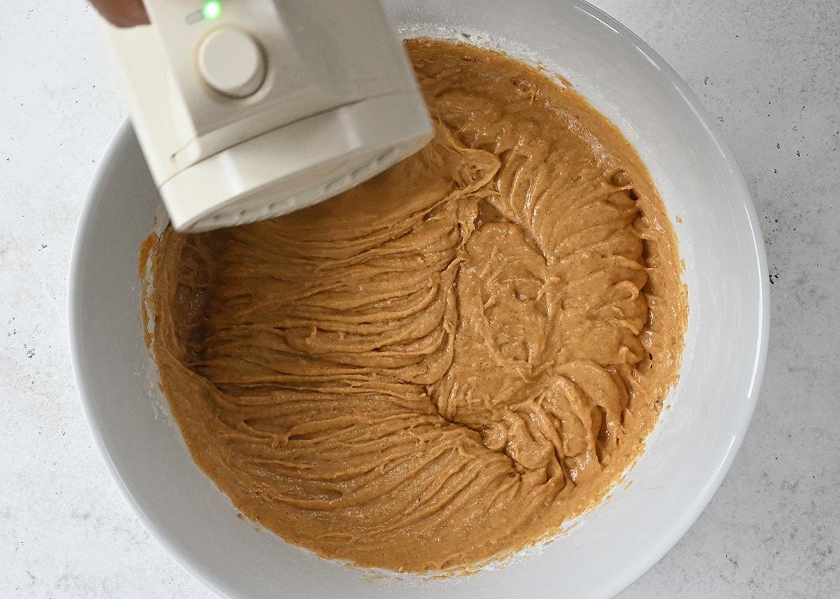 mixing batter for pumpkin bread