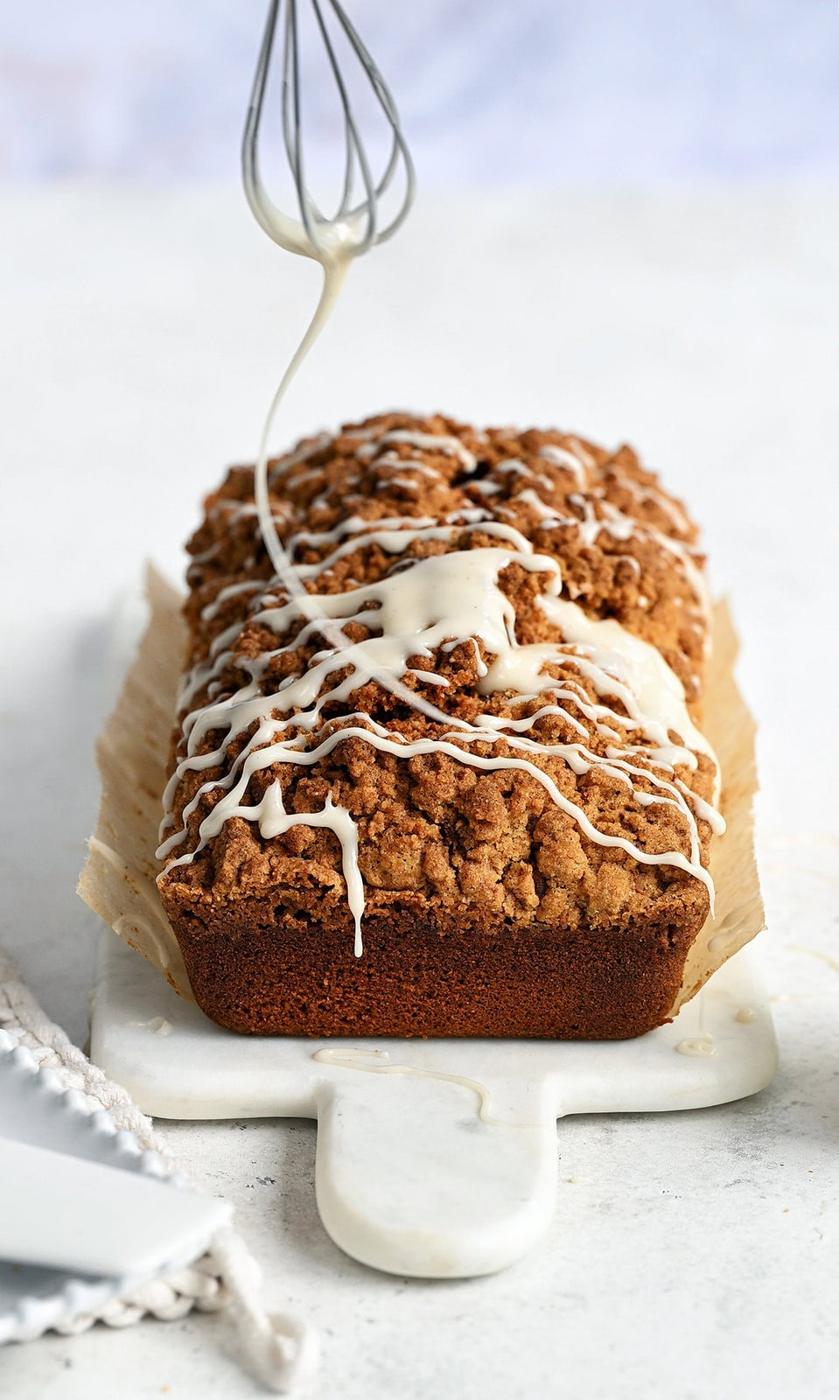 drizzling pumpkin apple bread with a sticky glaze