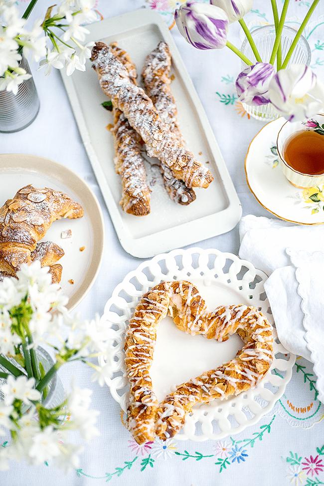 table set with various plates with croissants
