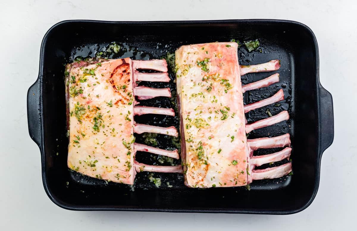 Marinated rack of lamb in a ceramic dish