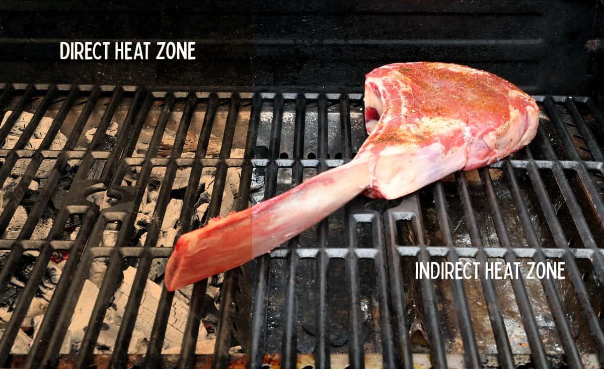 barbecue set for two zone cooking with coals on left and a cool side on the right with a steak