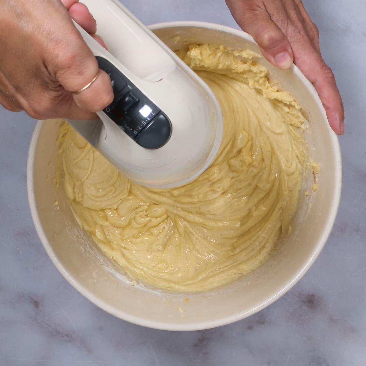 beating rhubarb cake batter with an electric hand mixer