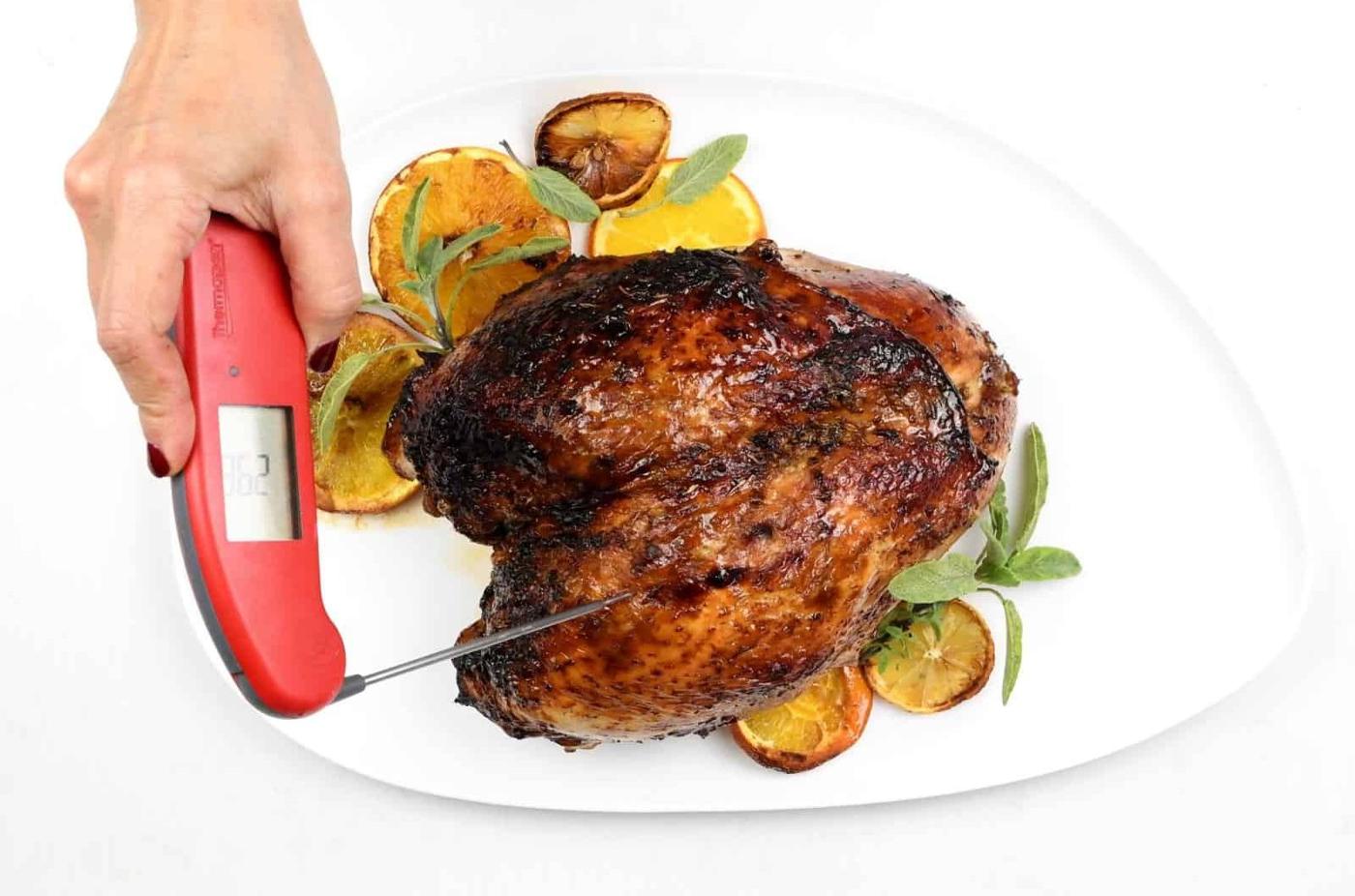 Checking temperature of roast turkey crown