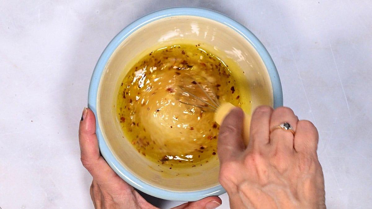 making salad dressing in a bowl