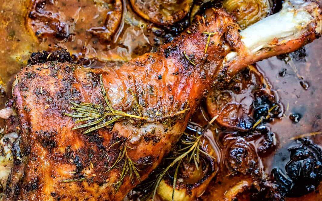 two roasted turkey legs on a roasting tray