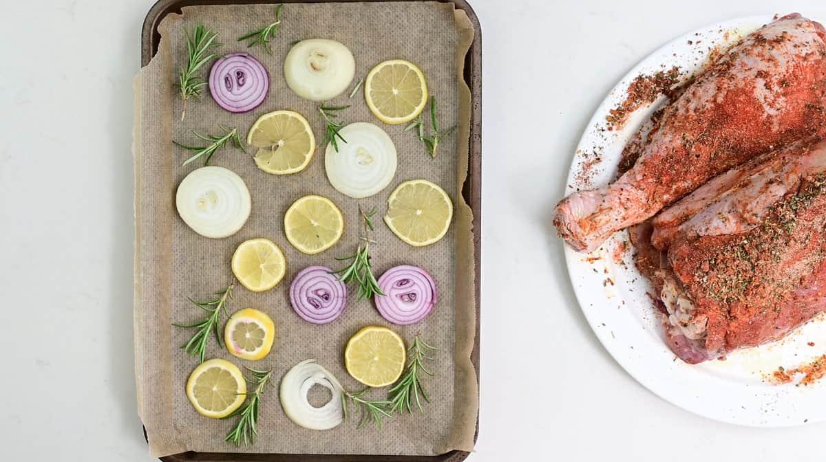 tray with rosemary, lemon and onion slices
