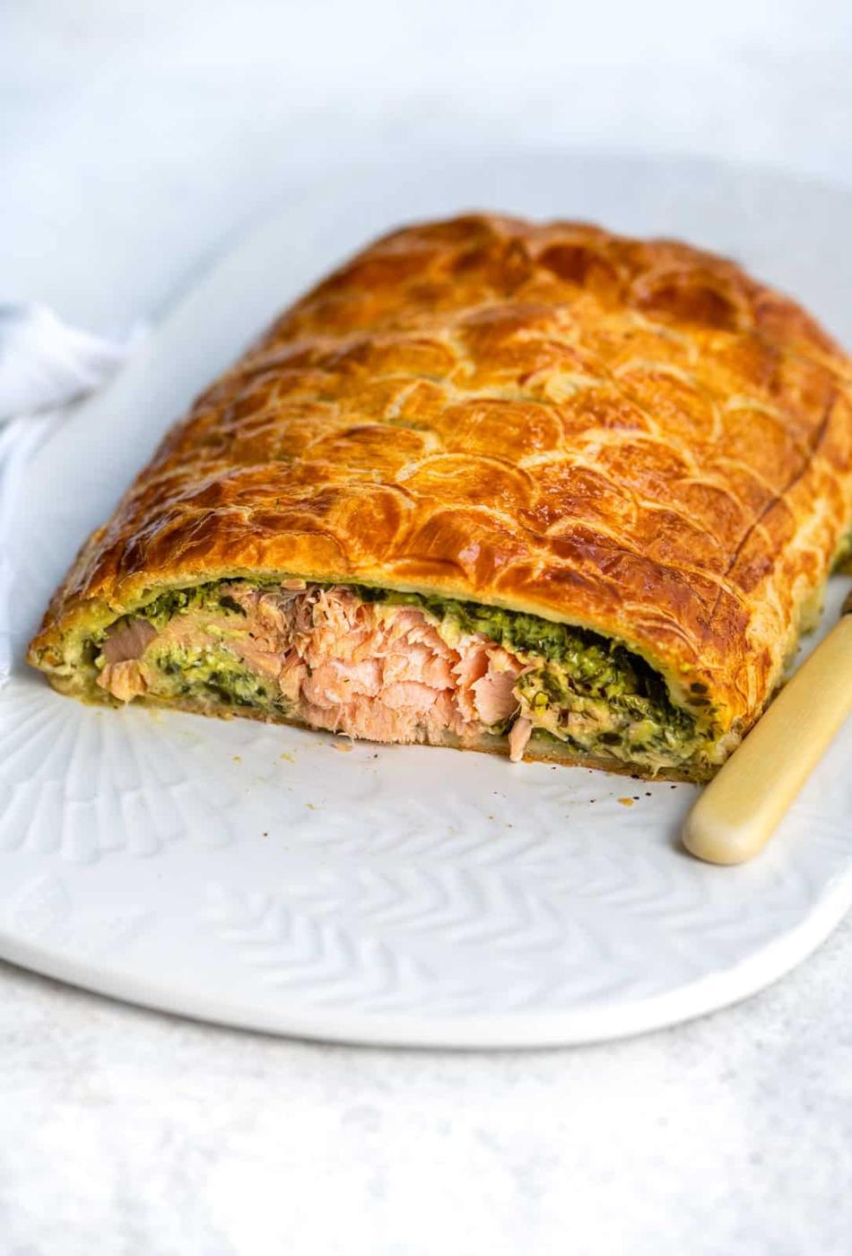 Salmon Wellington with slice cut to show the filling