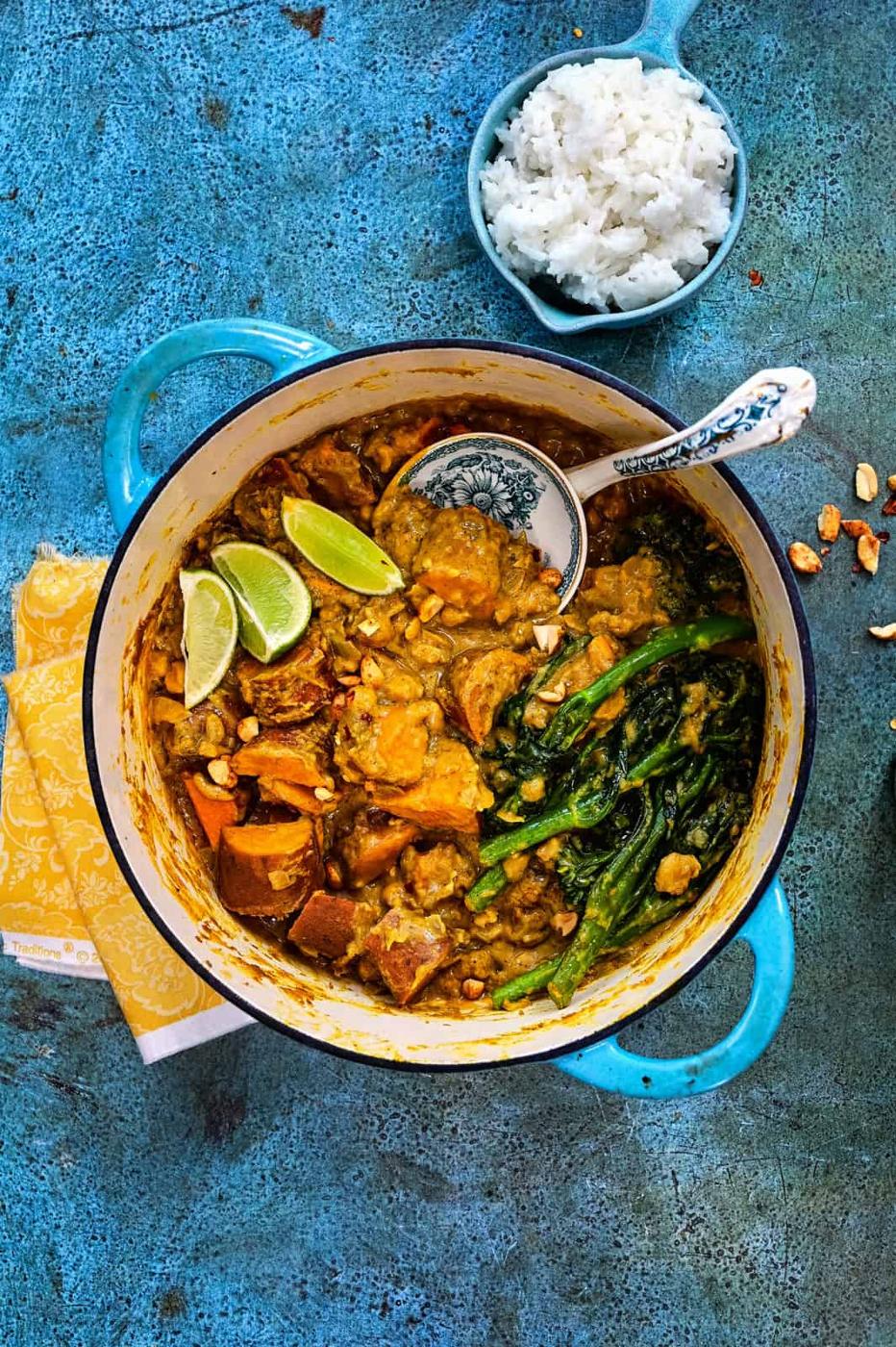 Pot of vegan sweet potato curry with rice on the side