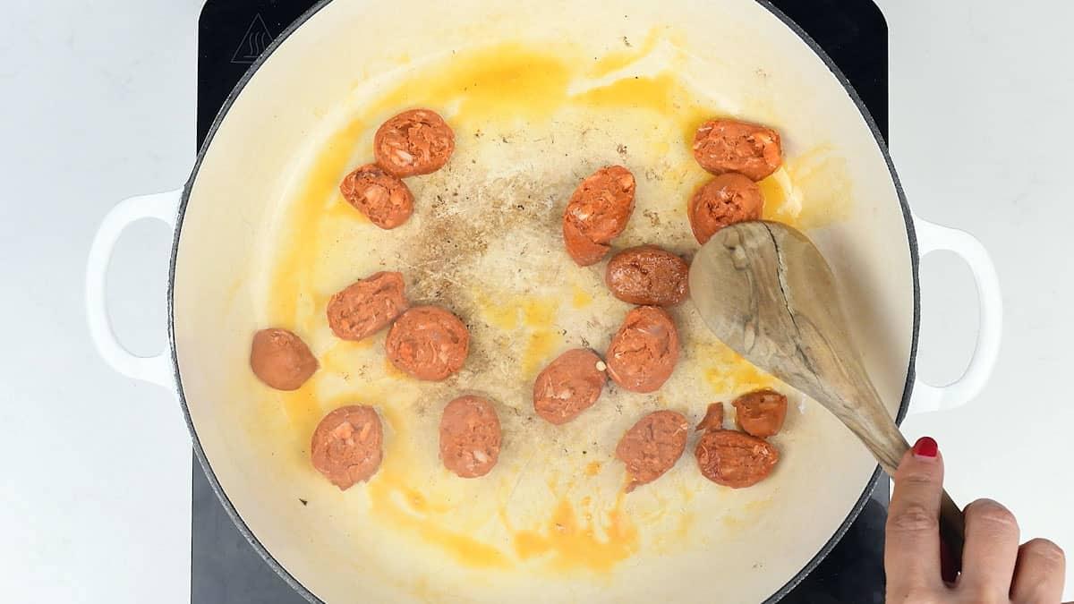 cooking sliced chorizo in a pan