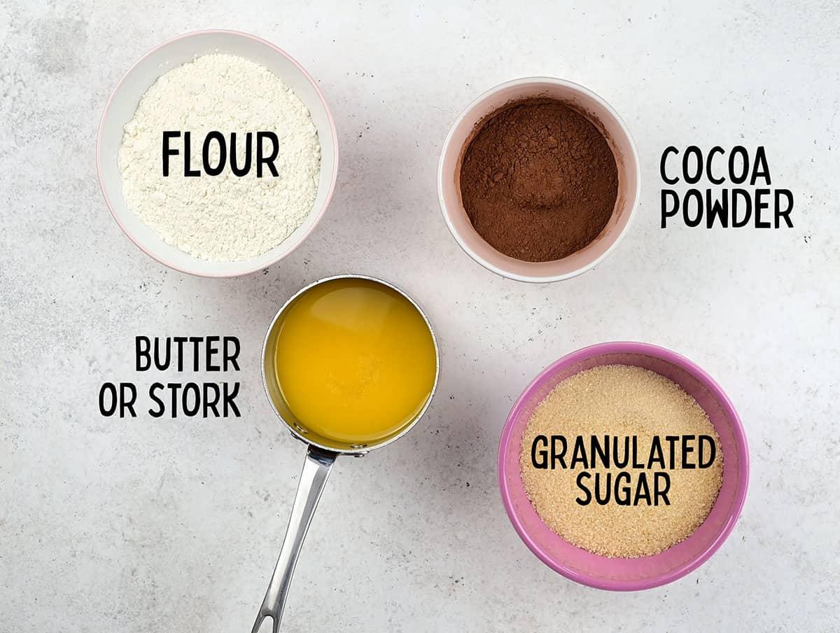 flour, cocoa powder, granulated sugar and melted butter in bowls