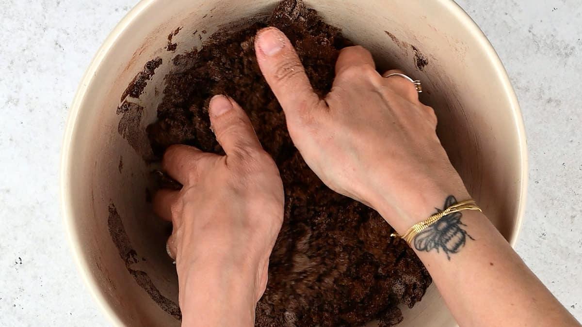 rubbing melted butter into flour, sugar and cocoa powder