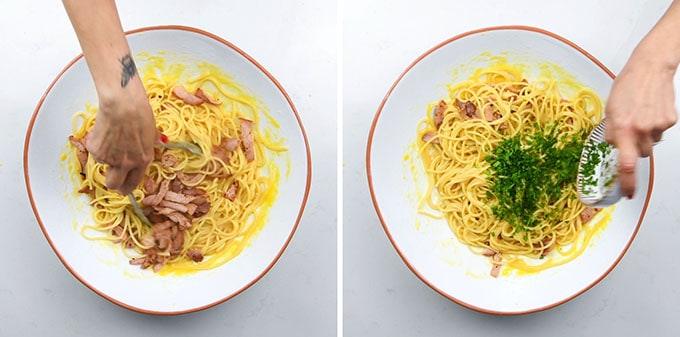 Two side-by-side images show hands mixing cooked pasta with bacon and egg yolk in a white bowl (left), then adding chopped herbs to the pasta (right) – a step-by-step look at an authentic Carbonara recipe on a white surface.