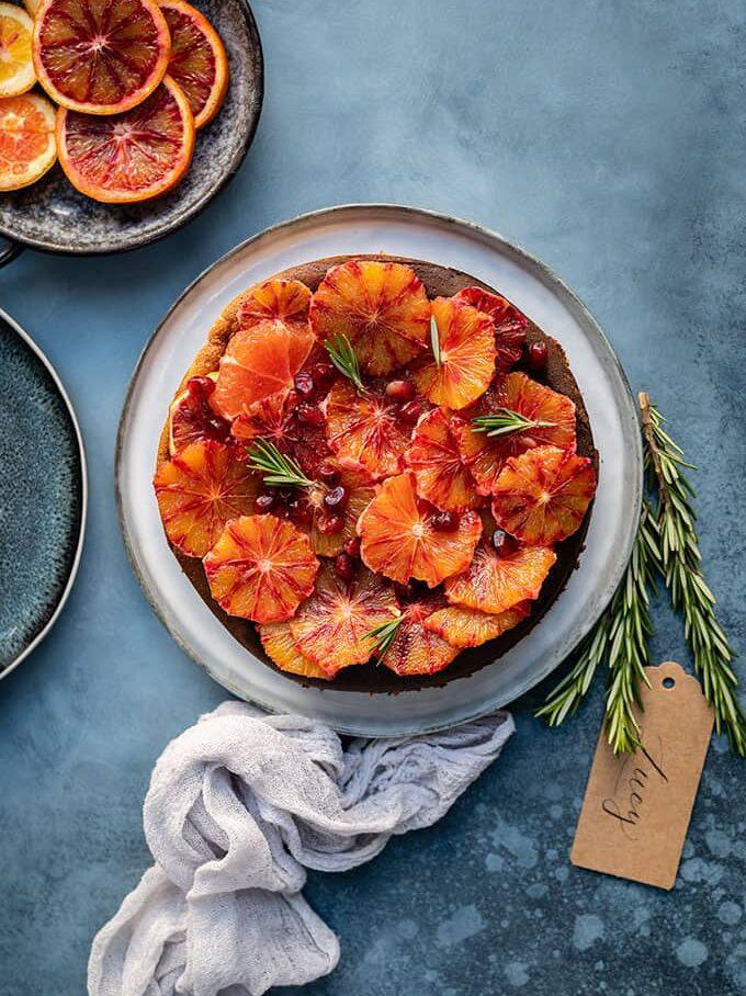 A crustless Slimming World cheesecake decorated with slices of orange and rosemary.