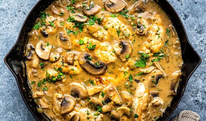 Close up on a skillet of slimming-friendly chicken stroganoff with mushrooms and parsley garnish