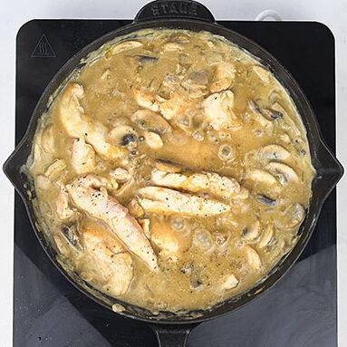 Chicken strips and mushrooms simmering in creamy stroganoff sauce