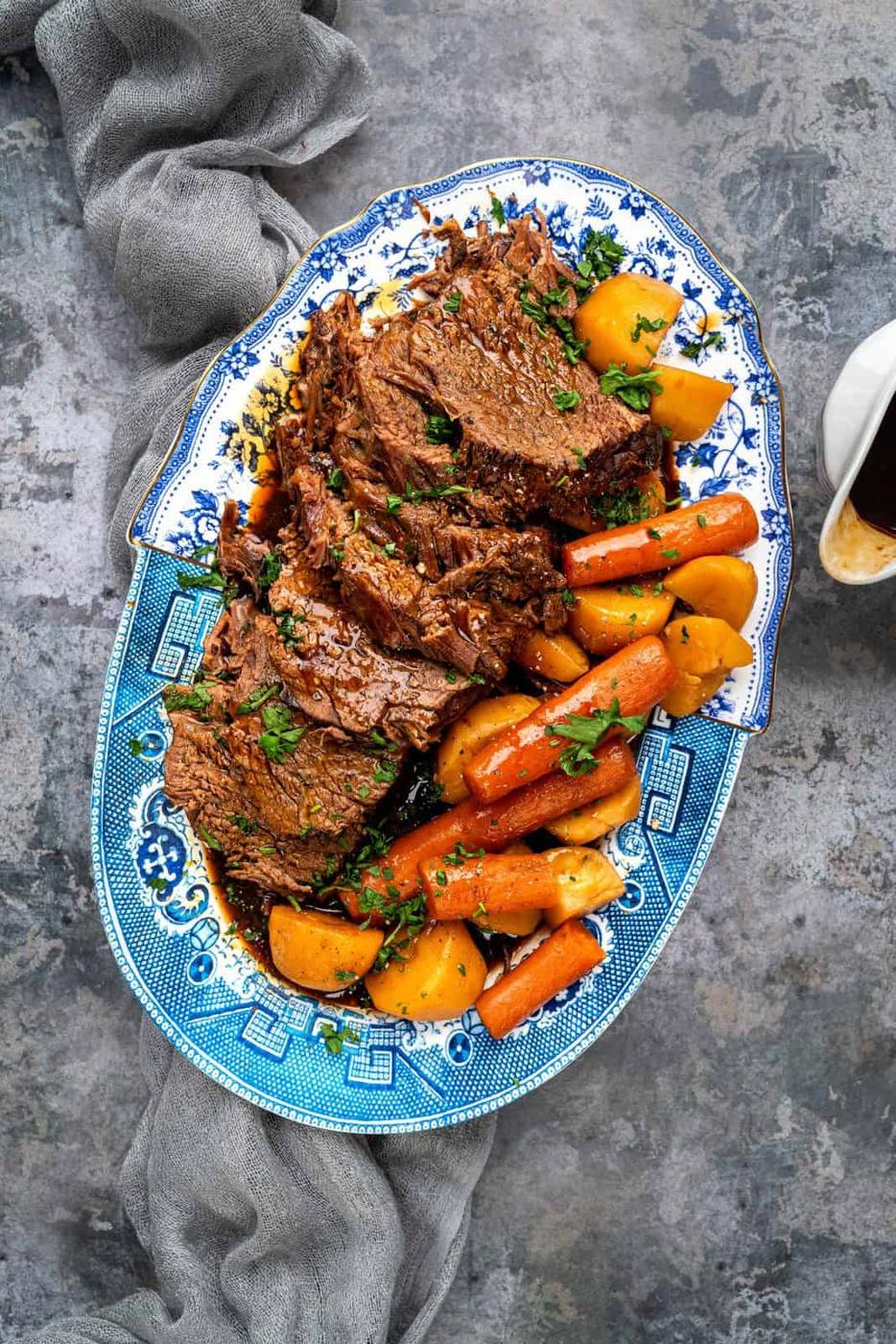 Platter of slow cooker beef roast with carrots and potatoes