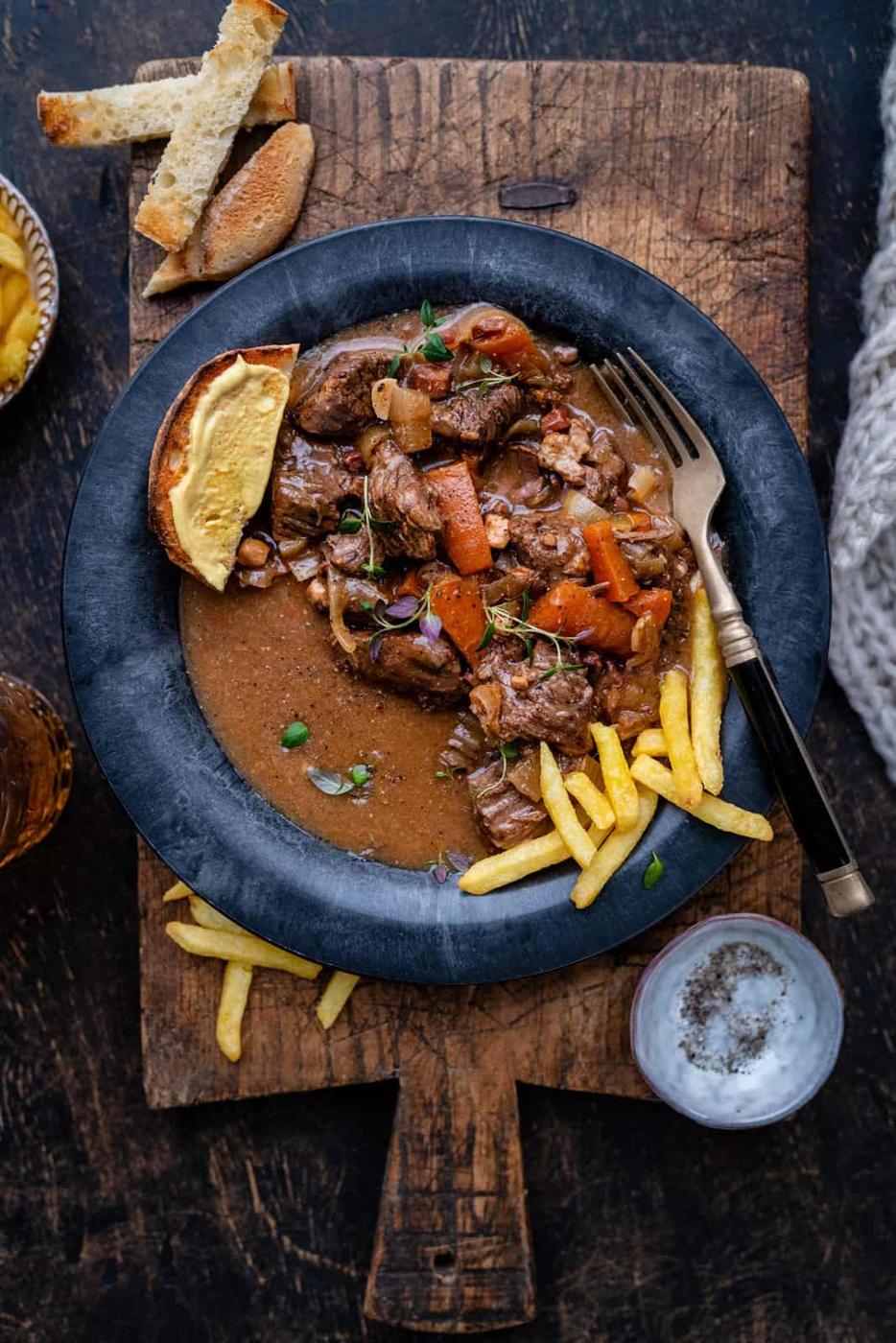 Overhead photo of slow cooker beef and beer stew in a dark bowl