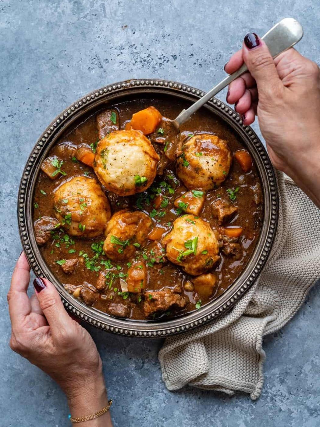 Beef stew with dumplings in a bowl