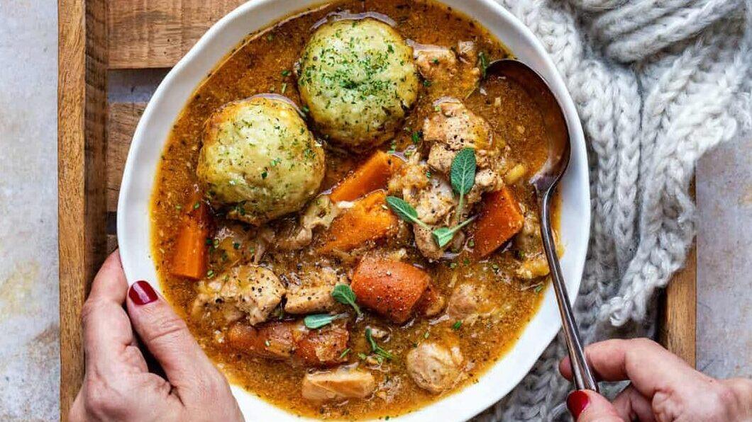 Bowl of crockpot chicken stew with dumplings
