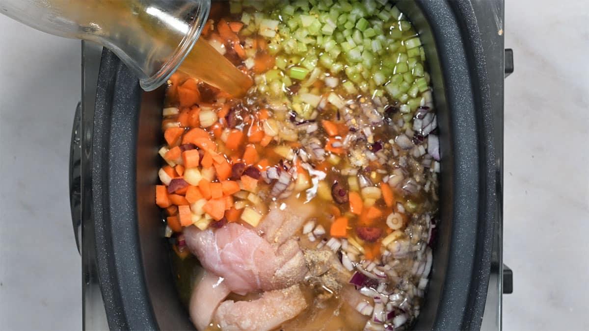 process shot making chicken gnocchi soup in a slow cooker