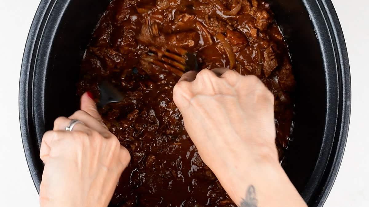 shredding chunky chili using two forks