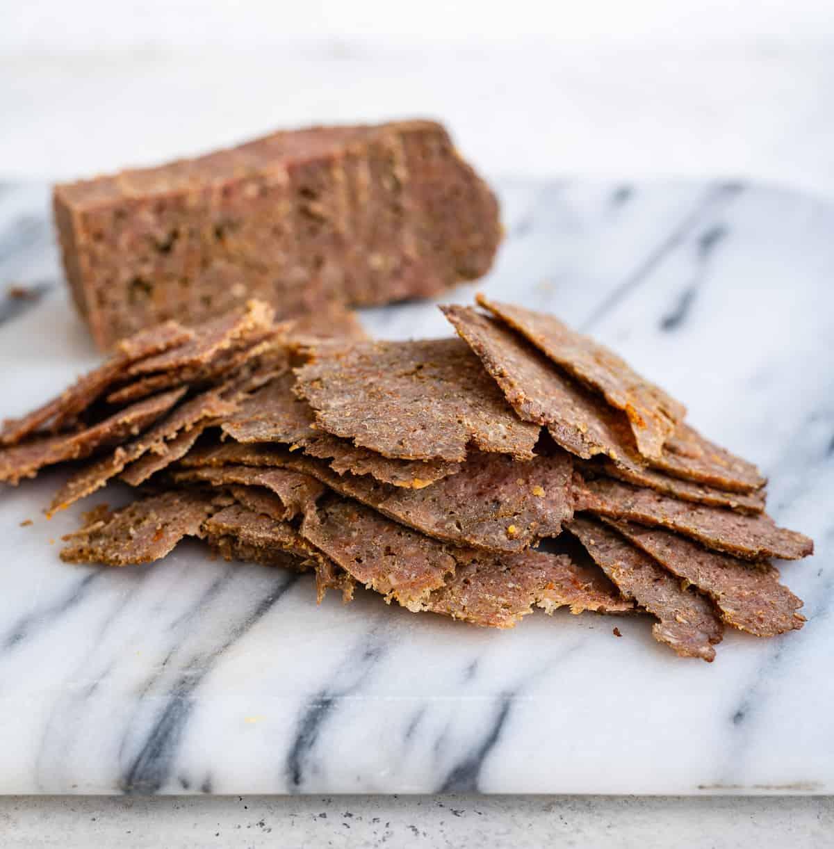 Homemade Beef Doner meat sliced into thin strips on a marble board