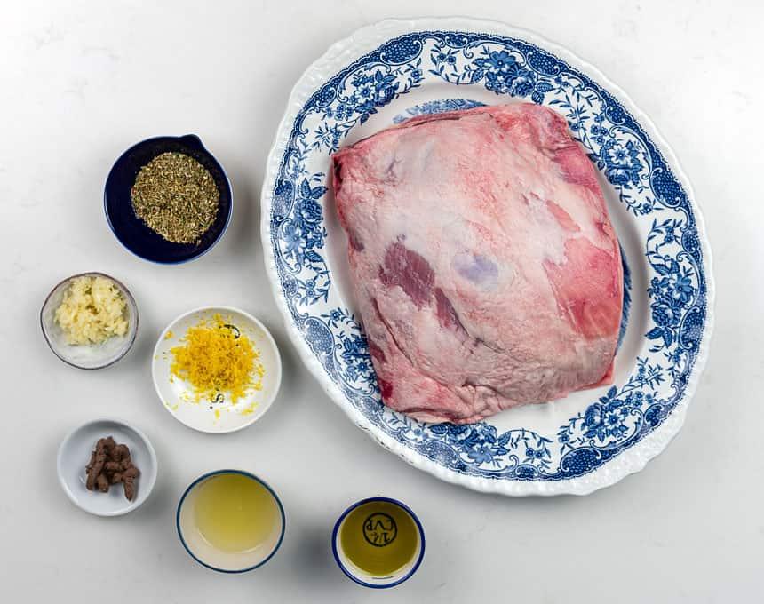 oregano, garlic, lemon juice, olive oil, lemon zest with platter of raw lamb on the side