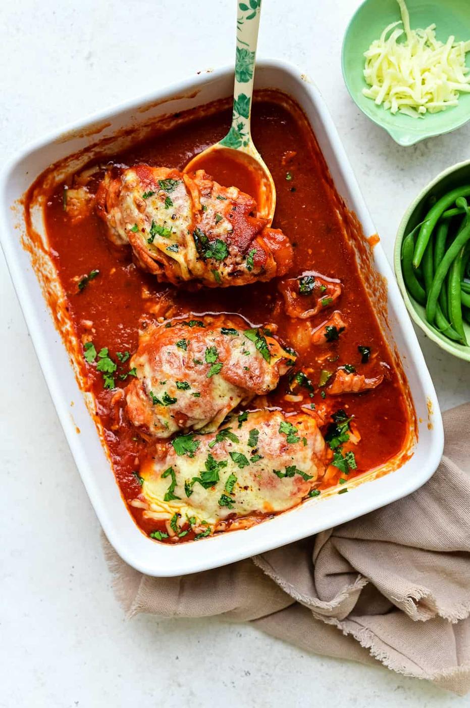 Three chicken breasts topped with grilled cheese baked in barbecue sauce