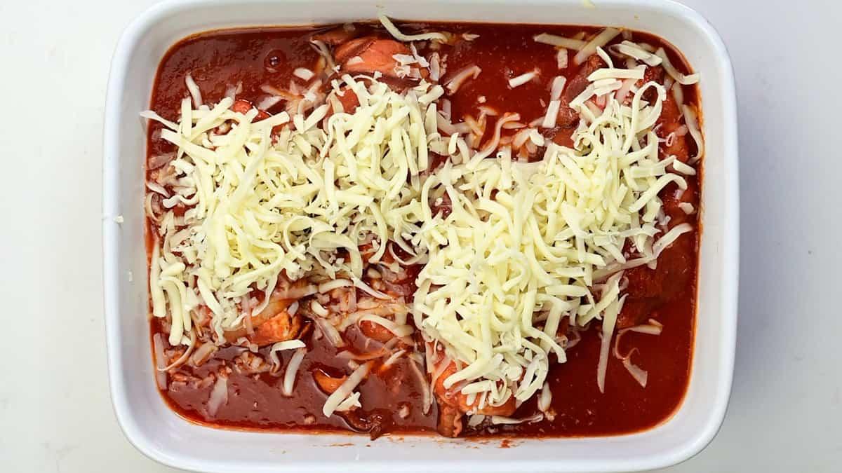 Hunters chicken topped with grated cheese ready for the oven