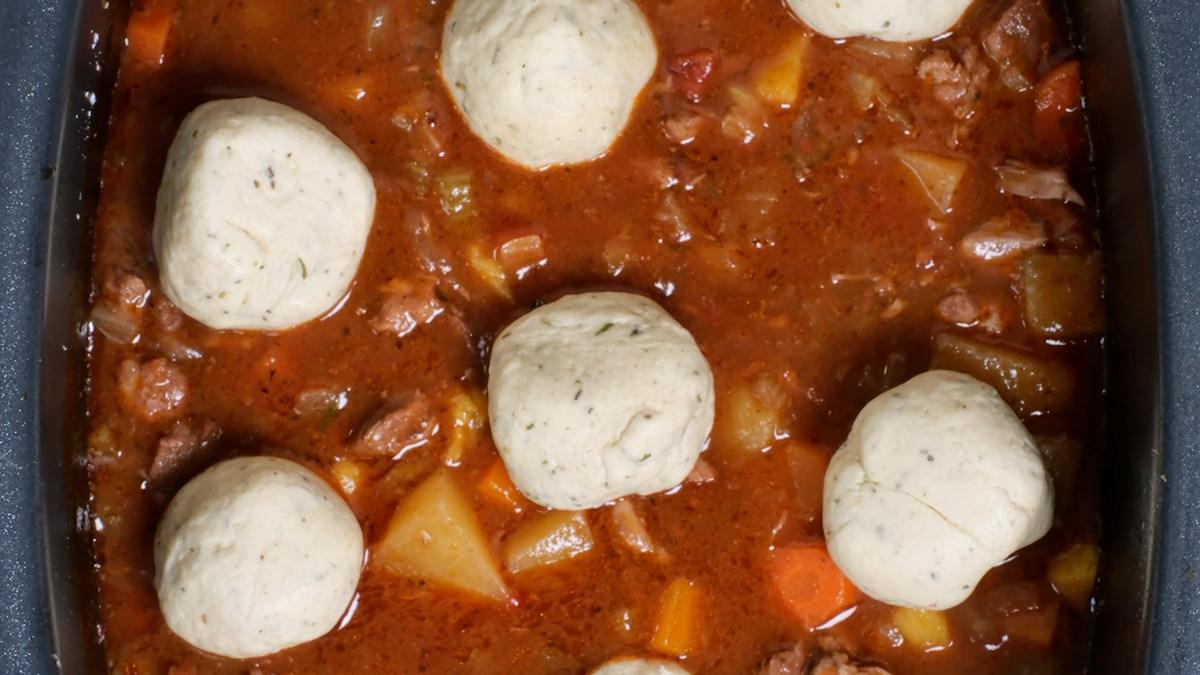 dumplings on top of casserole in a crock pot