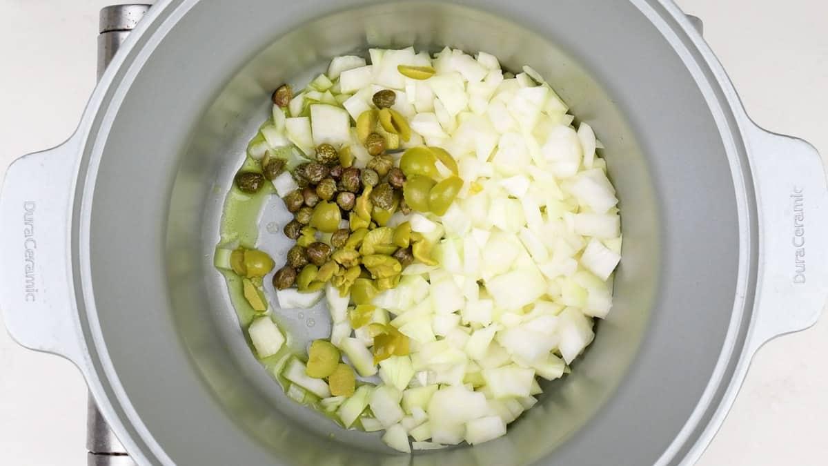 sauteing onions capers and olives in a slow cooker