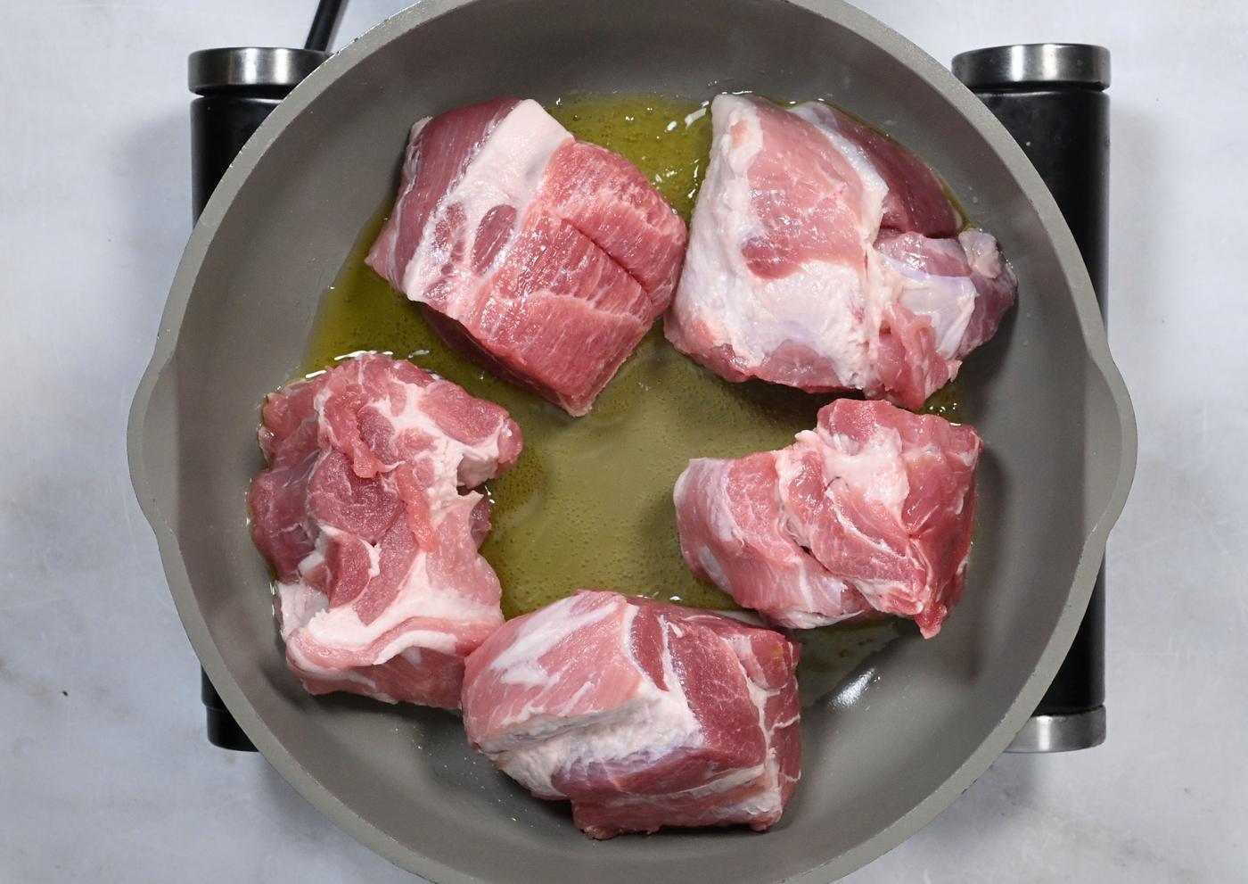 searing pork in a skillet