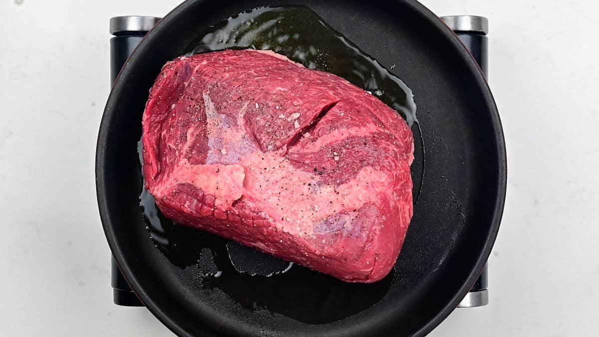 Searing beef joint in a skillet