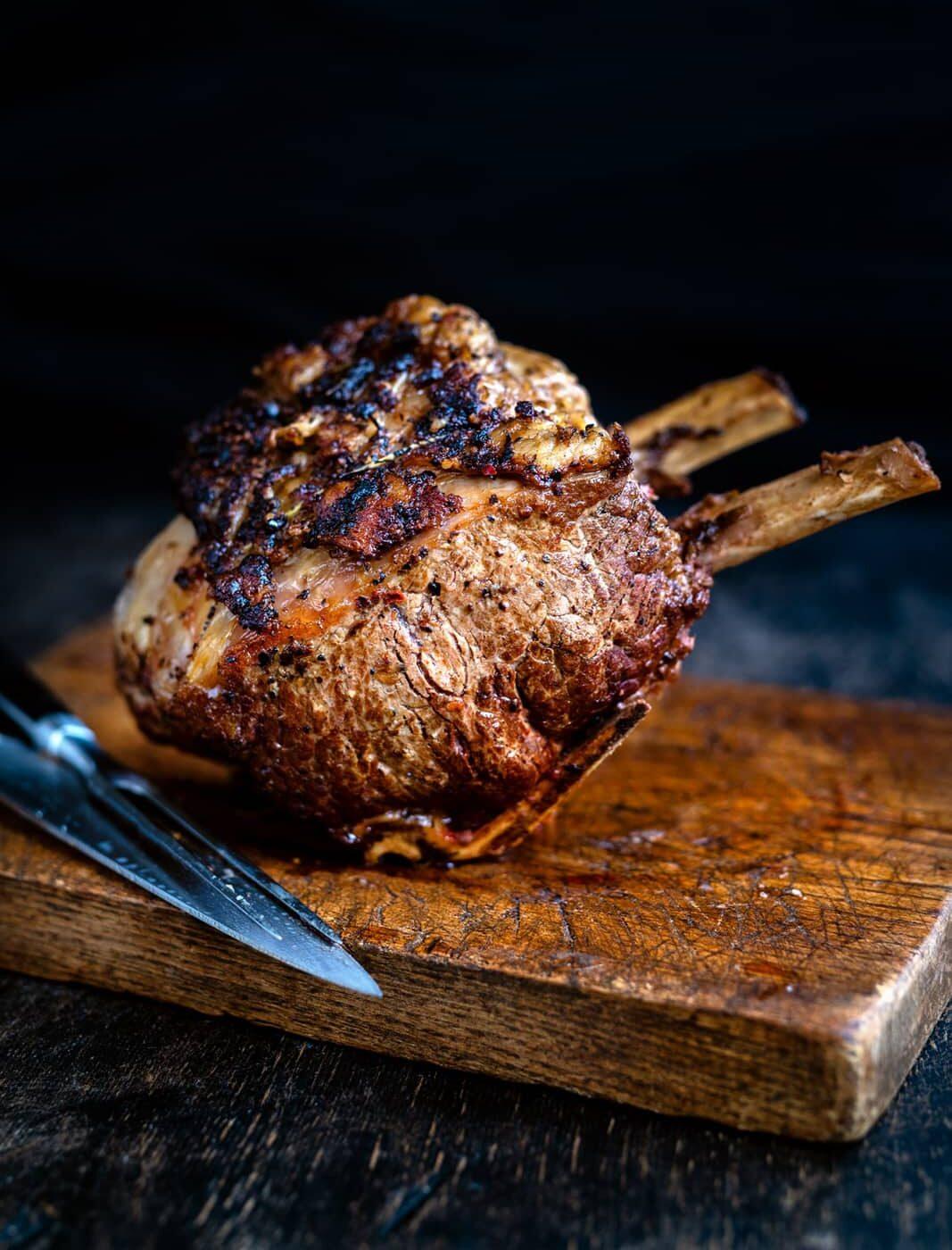 Standing Rib Roast resting on a wooden board