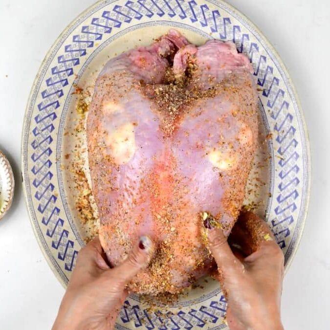 rubbing turkey with spices and seasoning