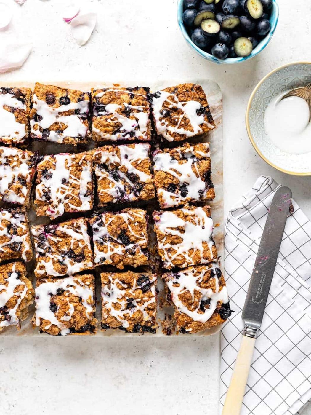 Blueberry crumb cake cut into squares on a marble board