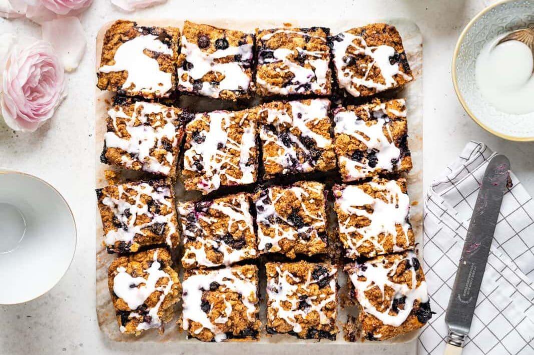 Top down view of blueberry cake cut into 16 squares