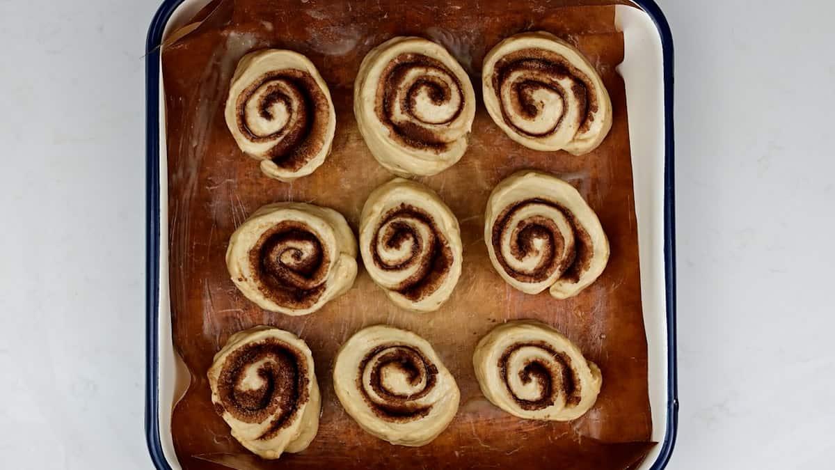 sourdough cinnamon rolls in a baking tin