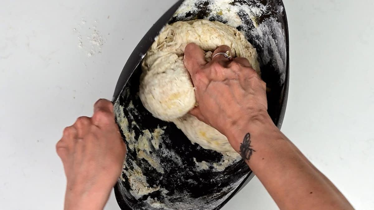 mixing sourdough in a bowl