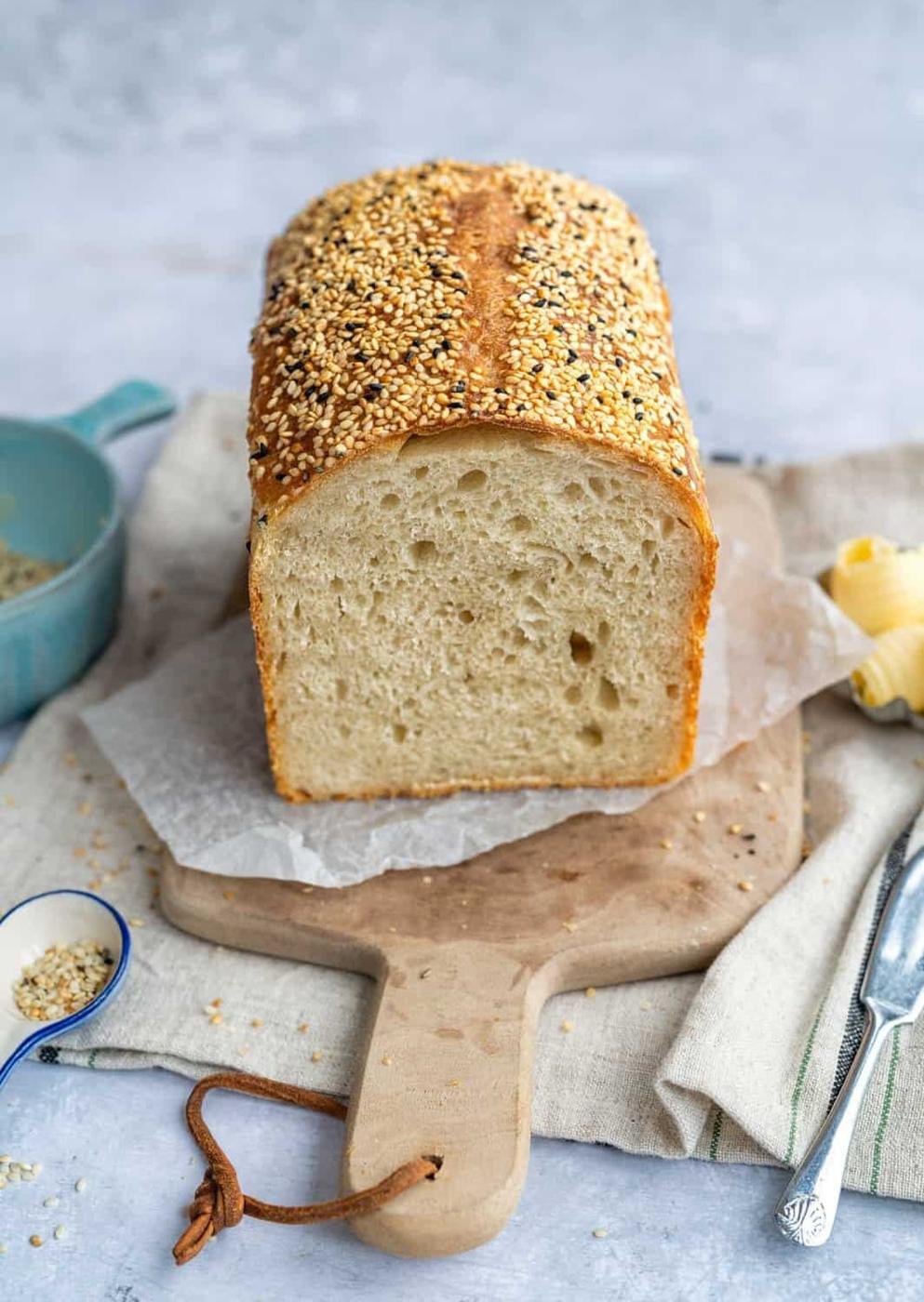 Sourdough Sandwich Bread, sliced, on a wooden board