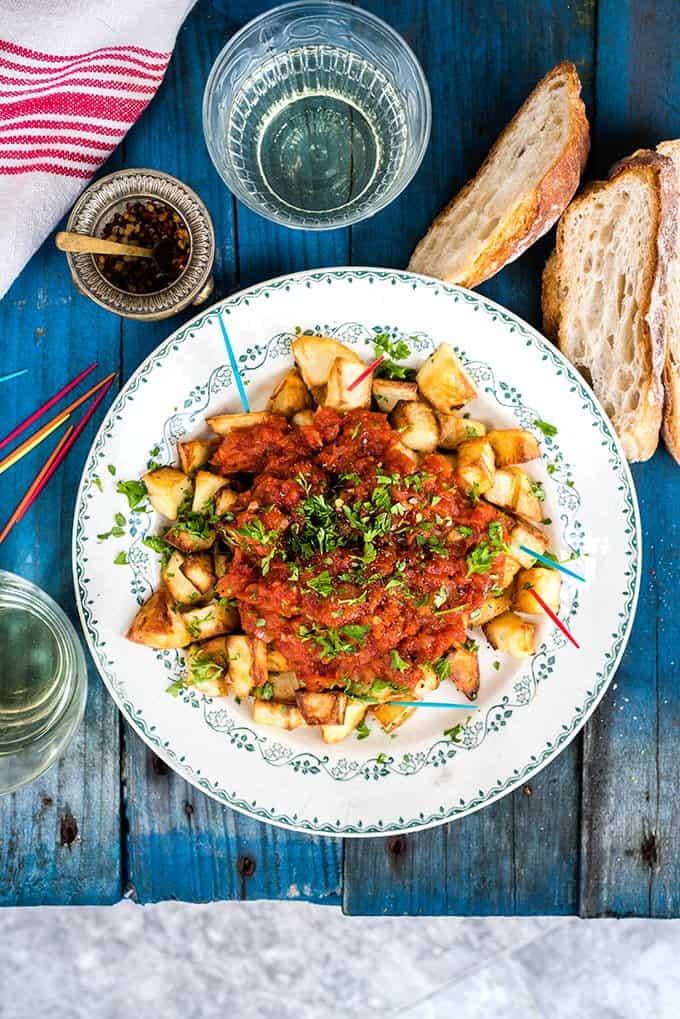 Spanish oven-baked Patatas Bravas with sea bass